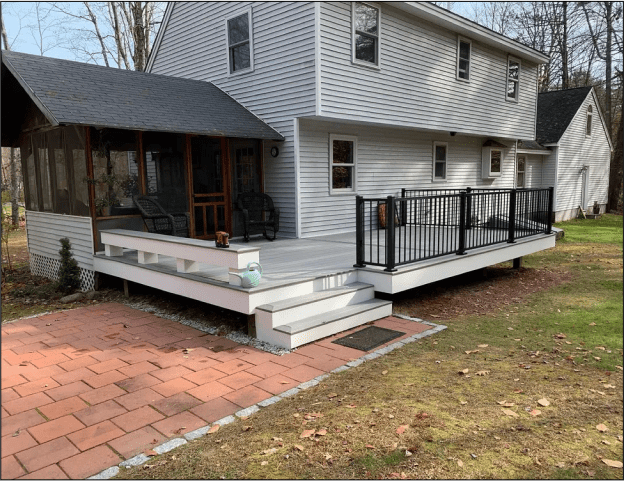 White house with porch and patio area.
