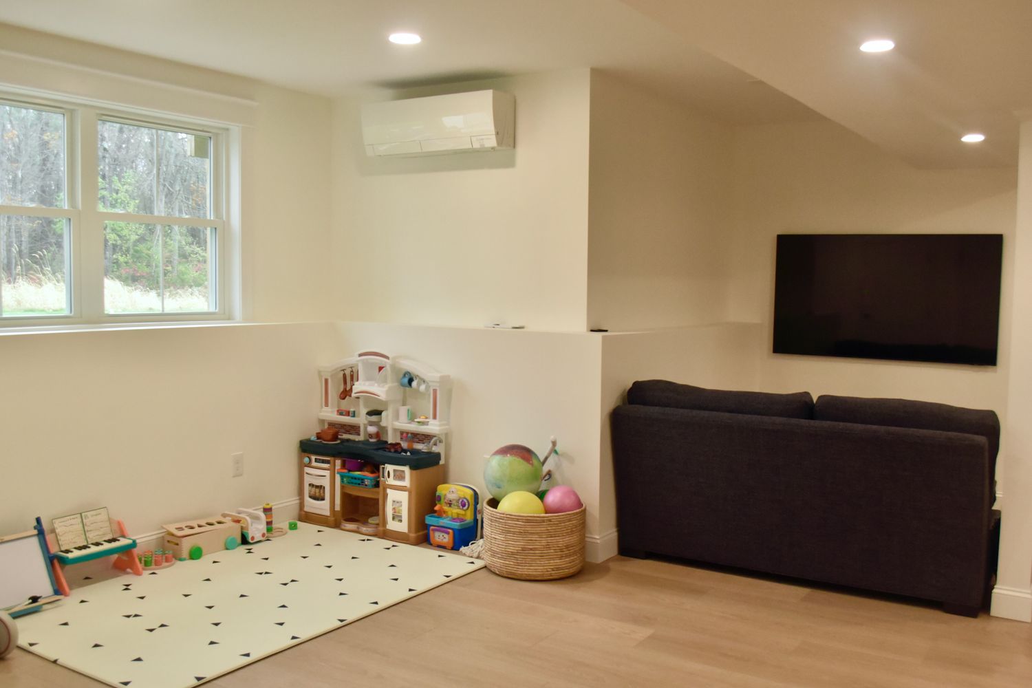 Cozy family room with play area and TV setup.