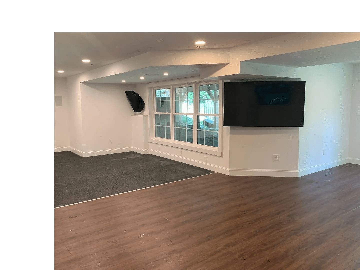 Modern living room with hardwood floors and a mounted TV.