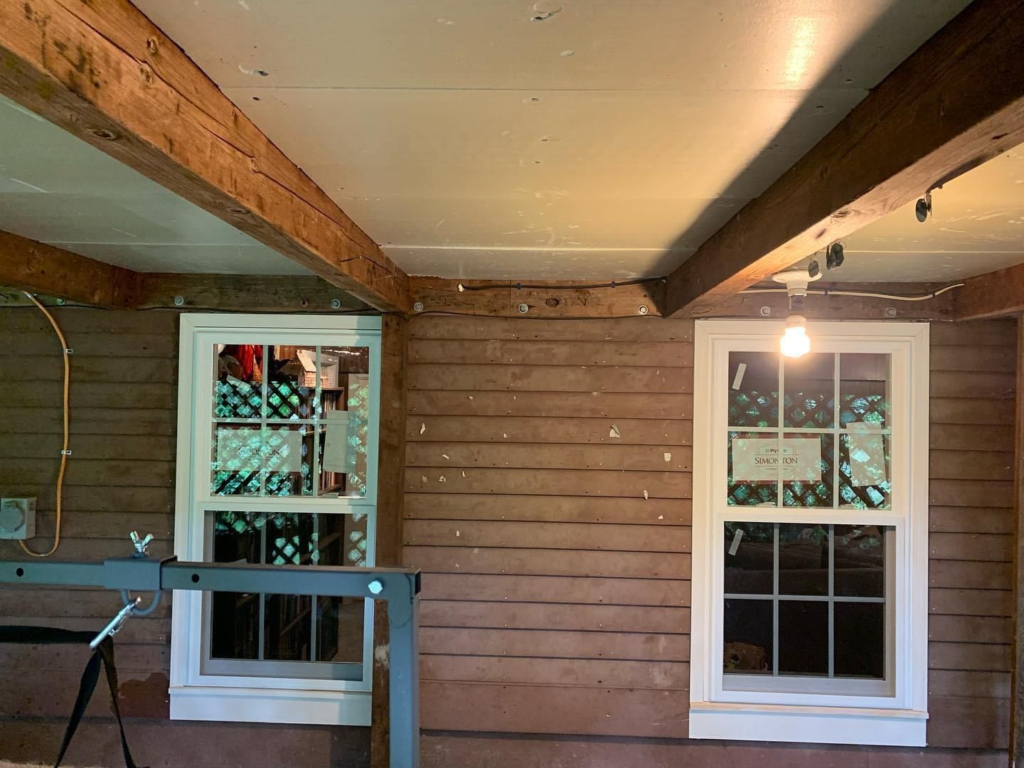 Rustic interior with wooden beams and windows.